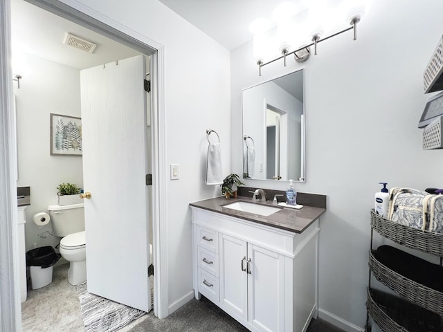 bathroom featuring vanity and toilet