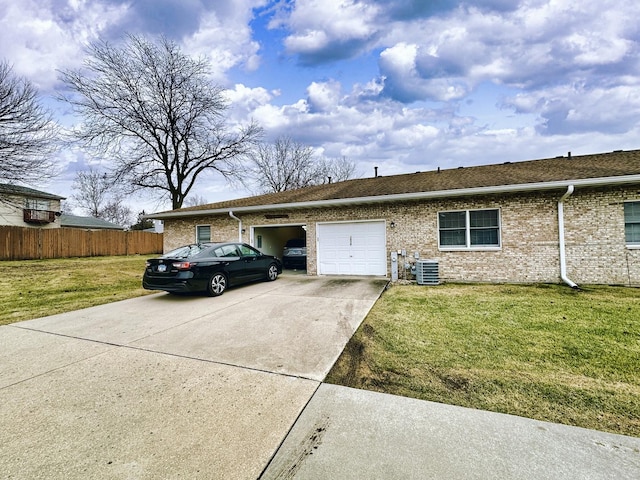 ranch-style home with central AC unit, a garage, and a front lawn