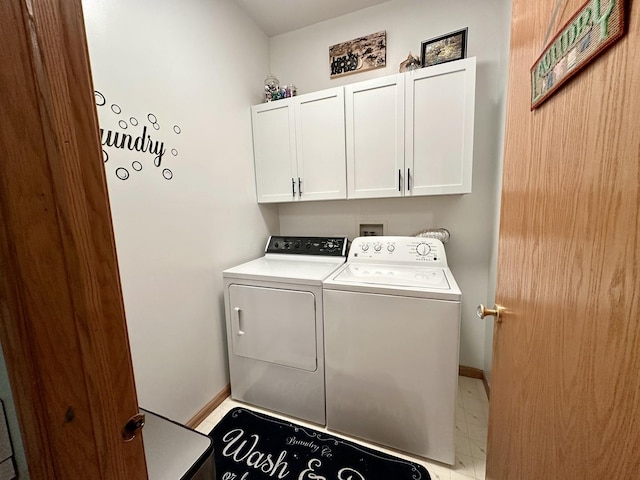 clothes washing area featuring cabinets and washing machine and dryer