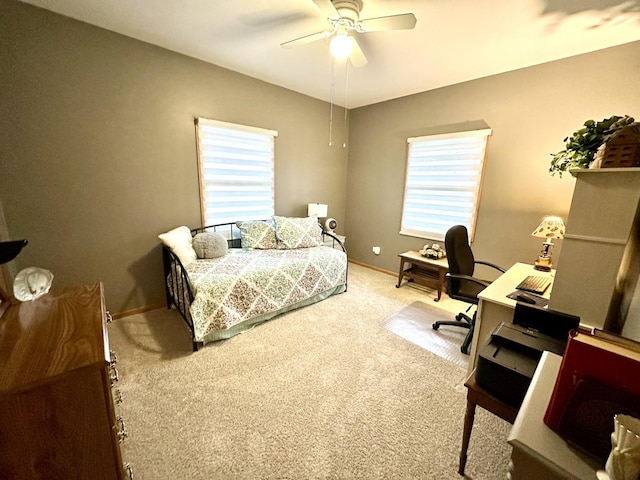 bedroom with ceiling fan, carpet flooring, and multiple windows