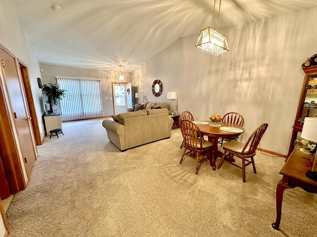 dining space with vaulted ceiling and light colored carpet