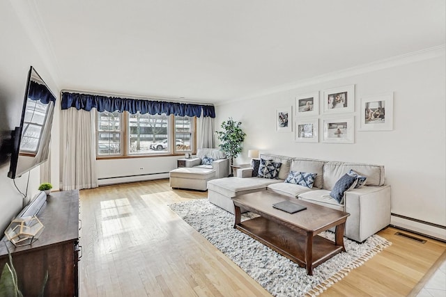 living room featuring ornamental molding, hardwood / wood-style floors, and baseboard heating