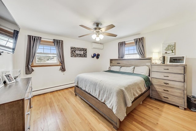 bedroom with light wood-type flooring, an AC wall unit, ceiling fan, and baseboard heating