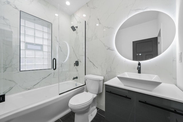 full bathroom featuring vanity, enclosed tub / shower combo, and toilet