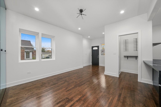 unfurnished living room with dark hardwood / wood-style floors