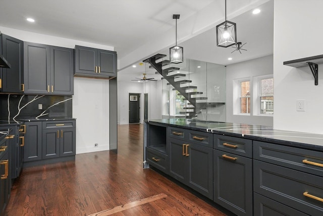 kitchen featuring tasteful backsplash, hanging light fixtures, dark hardwood / wood-style floors, gray cabinets, and ceiling fan