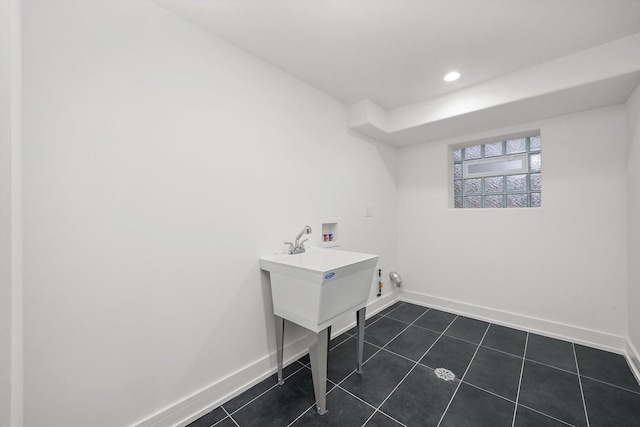 laundry area with dark tile patterned floors, washer hookup, and hookup for a gas dryer