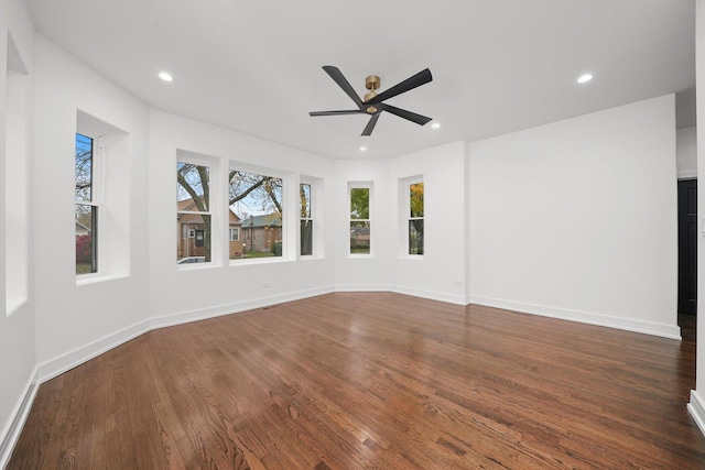 empty room featuring dark hardwood / wood-style floors and ceiling fan