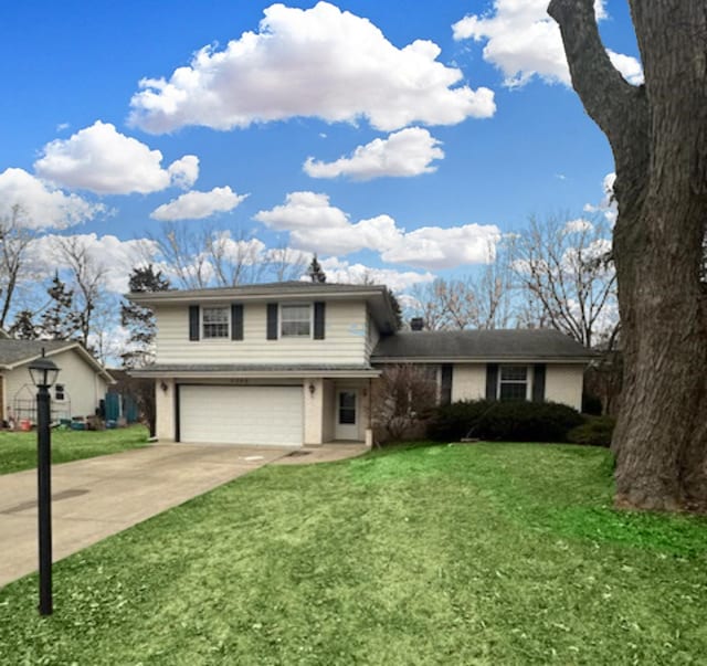 tri-level home with a garage and a front yard