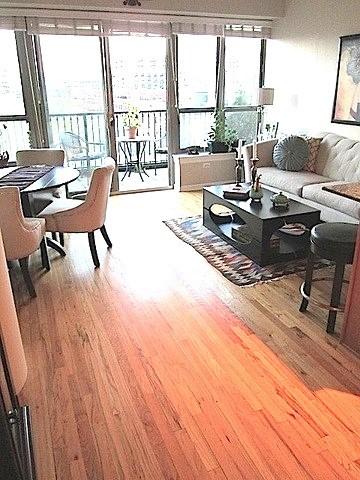 living room with a healthy amount of sunlight and hardwood / wood-style floors