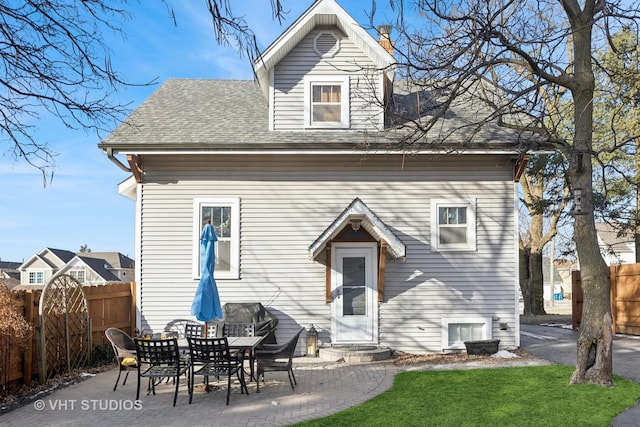 rear view of property with a yard and a patio area