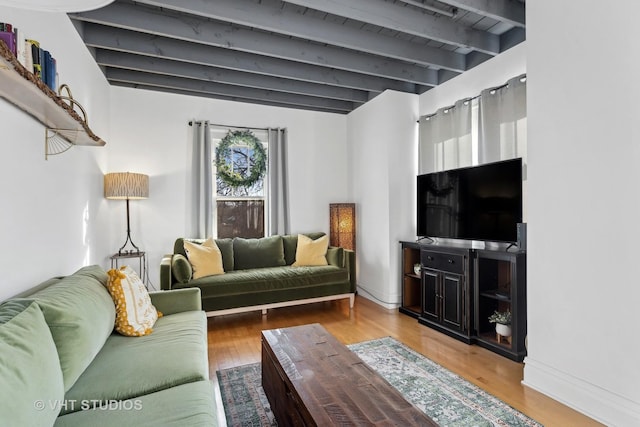 living room featuring beamed ceiling and hardwood / wood-style floors