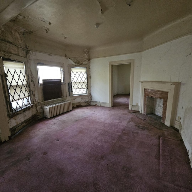 miscellaneous room featuring radiator heating unit, a premium fireplace, and carpet floors