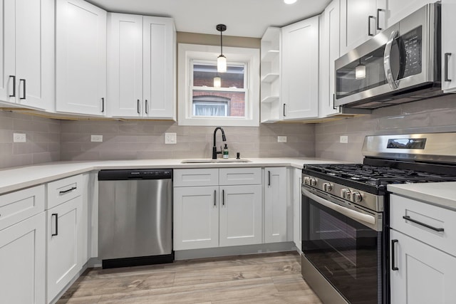 8126 S Dante Ave, Chicago, IL 60619 - kitchen with stainless steel appliances, light hardwood / wood-style floors, sink, and white cabinets