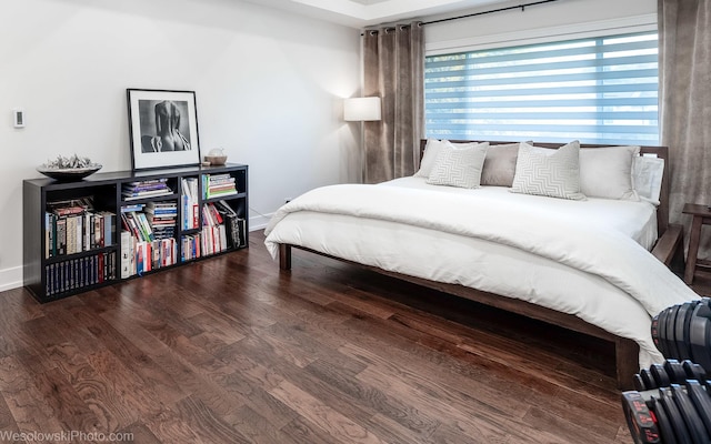 bedroom with dark hardwood / wood-style flooring