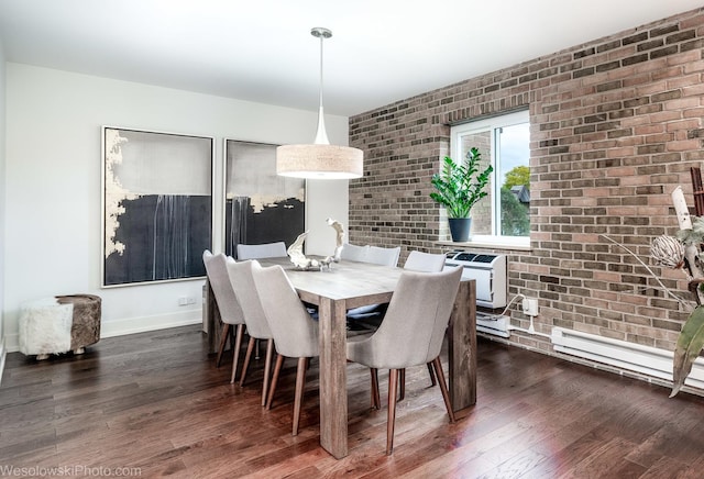 dining room with dark wood-type flooring, a baseboard radiator, brick wall, and an AC wall unit