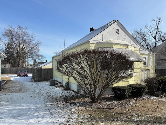 view of snow covered exterior featuring central AC unit