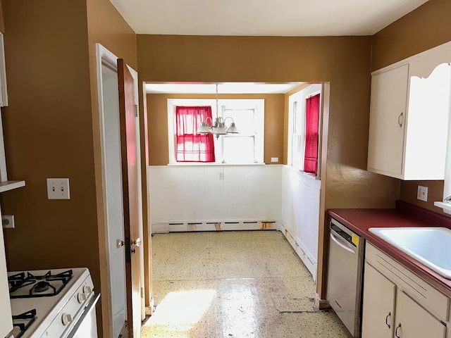 kitchen featuring white gas range, sink, white cabinets, hanging light fixtures, and stainless steel dishwasher