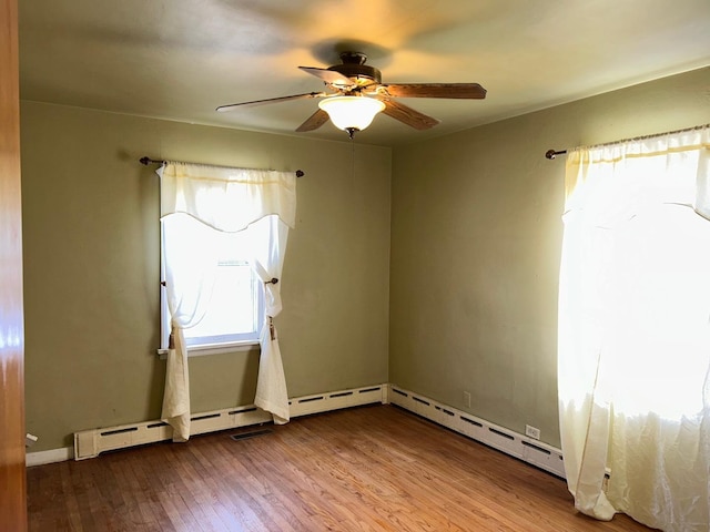 spare room featuring ceiling fan and hardwood / wood-style floors