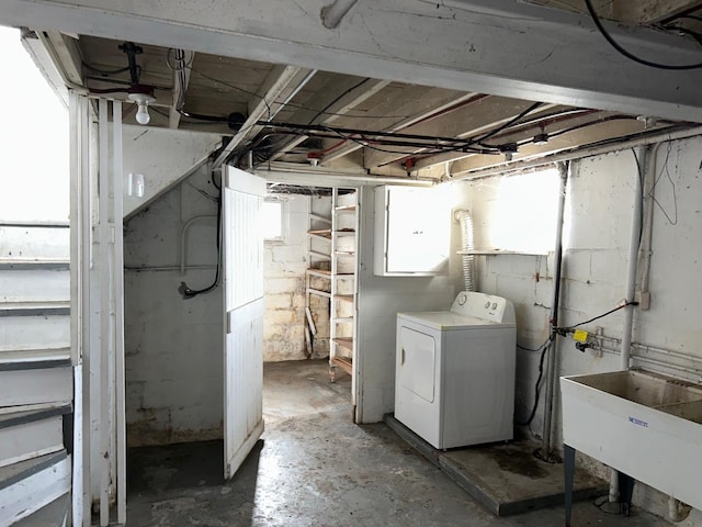 basement featuring sink and washer / dryer