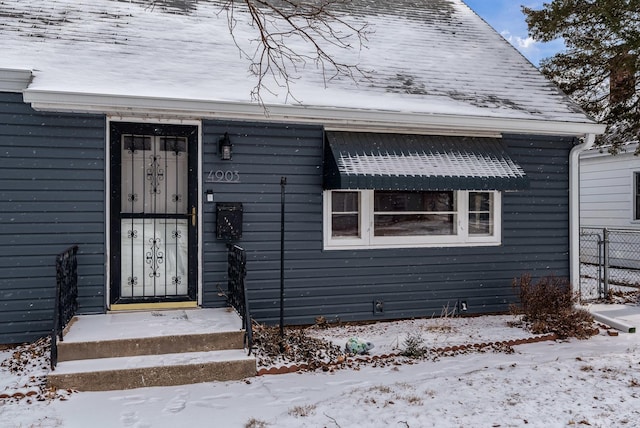 view of snow covered property entrance