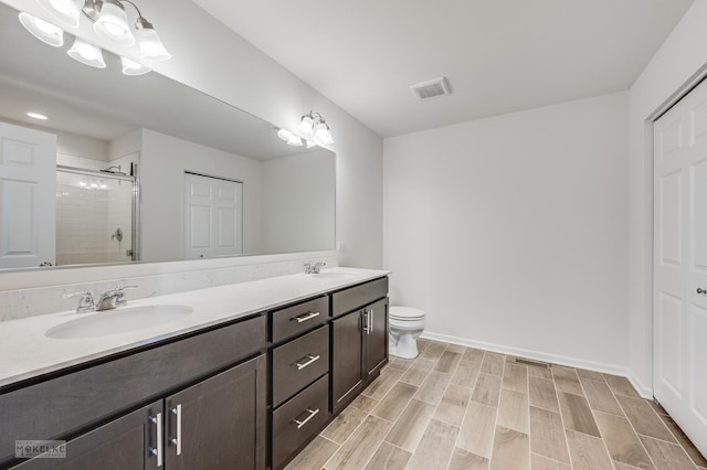 bathroom with vanity, walk in shower, and toilet