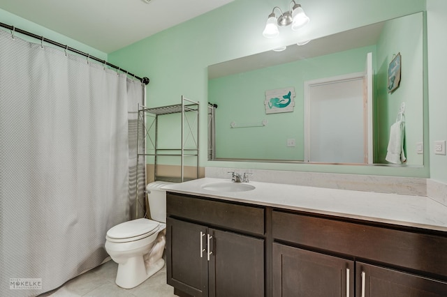 bathroom featuring vanity, tile patterned floors, and toilet