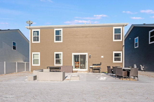 back of property featuring a fire pit and a patio area