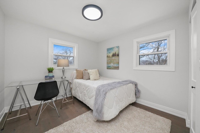 bedroom with dark hardwood / wood-style flooring