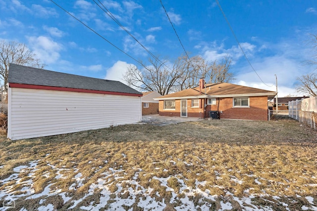 snow covered property with a lawn and central air condition unit