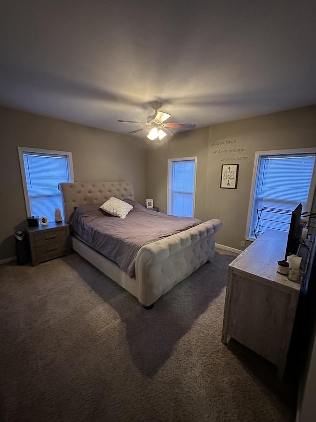 carpeted bedroom with lofted ceiling, ceiling fan, and baseboards