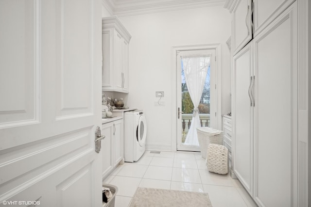 laundry area with cabinets, ornamental molding, and light tile patterned floors