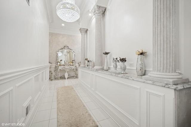 bathroom with tile patterned floors, ornamental molding, a chandelier, and ornate columns