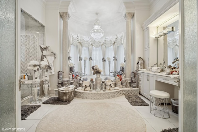 bathroom featuring tile patterned flooring, crown molding, vanity, and decorative columns