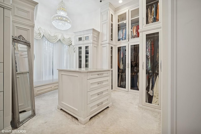 spacious closet with an inviting chandelier