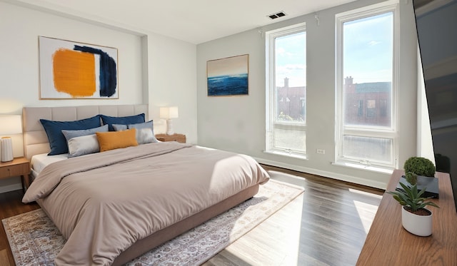 bedroom with dark hardwood / wood-style floors