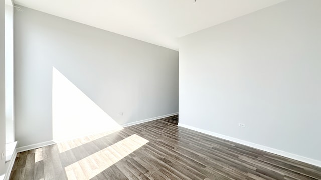 unfurnished room featuring dark hardwood / wood-style floors