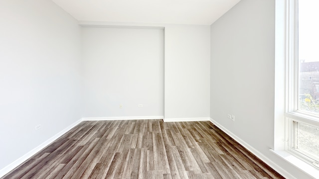 unfurnished room with hardwood / wood-style floors