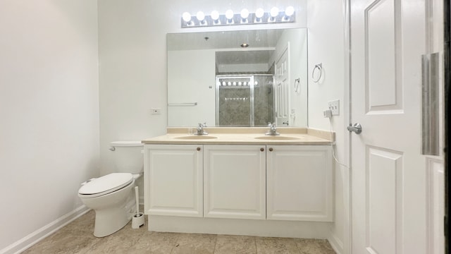 bathroom with vanity, a shower with shower door, and toilet