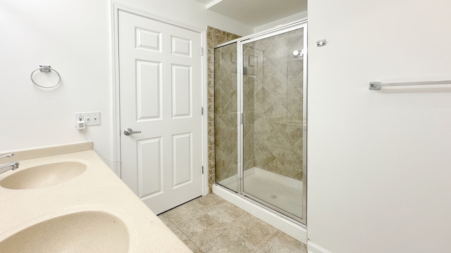 bathroom featuring vanity, an enclosed shower, and tile patterned flooring