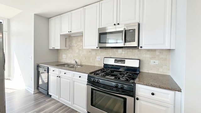 kitchen featuring white cabinetry, stainless steel appliances, and sink