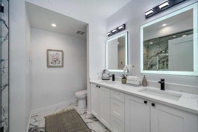 bathroom featuring vanity, toilet, and a shower with shower door