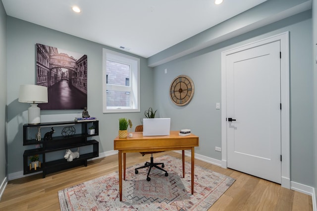 office area with light hardwood / wood-style floors