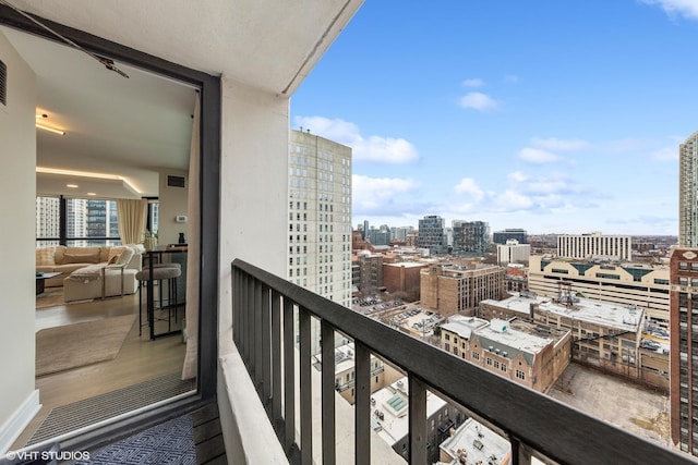 balcony with a view of city and visible vents