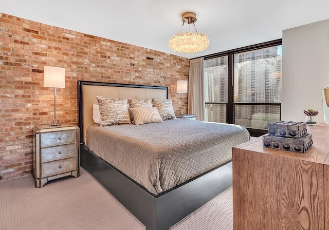 bedroom with brick wall and carpet flooring