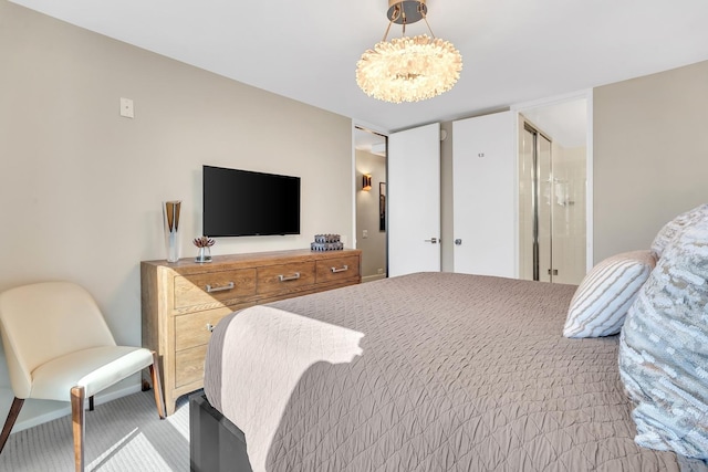 bedroom featuring an inviting chandelier and light colored carpet