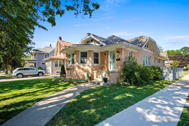 bungalow-style house with a front lawn