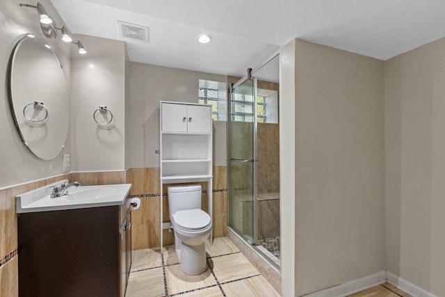 bathroom with vanity, an enclosed shower, tile patterned flooring, and toilet