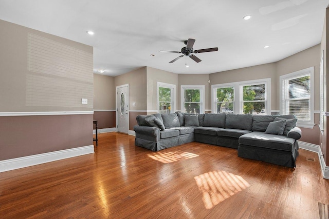 living room featuring hardwood / wood-style flooring and ceiling fan