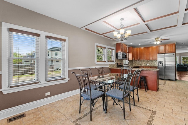 dining room featuring a healthy amount of sunlight, coffered ceiling, ceiling fan with notable chandelier, and light tile patterned floors